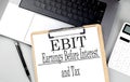 EBIT word on clipboard on laptop with calculator and pen Royalty Free Stock Photo