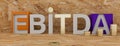 EBITDA word built with letter and stacked coins. 3d illustration Royalty Free Stock Photo