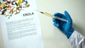 Ebola diagnosis on conclusion, hand holding medication in syringe treatment