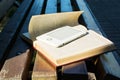 Ebook laying on a book on the bench. new technology concept