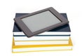 Ebook reader with empty screen on top of pile of paper books. Royalty Free Stock Photo