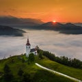 ÃÂ ebrelje, Slovenia - Aerial drone view of the beautiful hilltop church of St.Ivan Sv. Ivan Cerkev at sunrise with morning fog