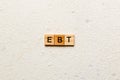 EBT word written on wood block. Abbreviation Earnings Before Taxes text on cement table for your desing, concept Royalty Free Stock Photo