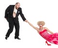 Eccentric Fat Man Dragging a Woman by the Hand Lying on Floor Royalty Free Stock Photo