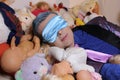 Eccentric man sleeping with mask , lots of dolls and stuffed animals