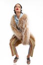 Eccentric model posing in a fur coat