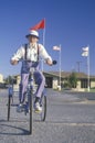 An eccentric senior citizen riding a tricycle