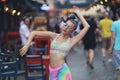 Eccentric Young Woman dancing in Street