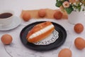 Eclair on a black plate with marble table Royalty Free Stock Photo