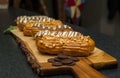 Eclair cakes on a wooden cutting board Royalty Free Stock Photo