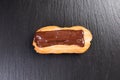 Eclair with chocolate topping. Royalty Free Stock Photo