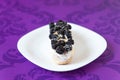 Eclair with cream and blackberies Royalty Free Stock Photo