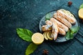 Eclair with lemon cream. Lemon dessert on a black stone plate. Top view. Rustic style Royalty Free Stock Photo