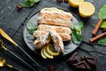 Eclair with lemon cream. Lemon dessert on a black stone plate. Top view. Rustic style Royalty Free Stock Photo