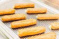 Eclairs on a baking sheet. Selective focus. Royalty Free Stock Photo