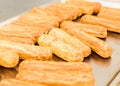 Eclairs on a baking sheet. Selective focus. Royalty Free Stock Photo
