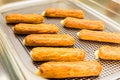 Eclairs on a baking sheet. Selective focus. Royalty Free Stock Photo