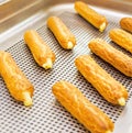 Eclairs on a baking sheet. Selective focus. Royalty Free Stock Photo