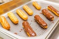 Eclairs on a baking sheet. Selective focus. Royalty Free Stock Photo