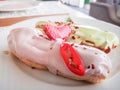 Eclairs with colored glaze on a white plate. Homemade eclairs cakes. Traditional eclairs, classics professional, eclairs french.