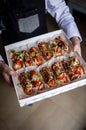 Eclairs with salmon, fresh vegetables and herbs, gourmet snacks.