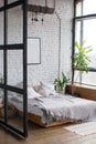 Eclectic bedroom interior with plants.