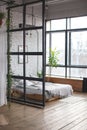 Eclectic bedroom interior with plants.