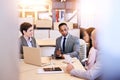 Eclectic group of four business professionals conducting a meeting Royalty Free Stock Photo