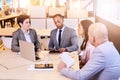 Eclectic group of four business professionals conducting a meeting Royalty Free Stock Photo