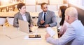 Eclectic group of four business professionals conducting a meeting Royalty Free Stock Photo