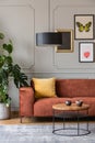 Eclectic living room with comfortable velvet corner sofa with pillows