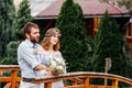 Eclectic rustic wedding couple stand on the bridge