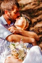 Eclectic wedding couple sitting and hugging on the bench