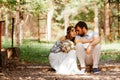 Eclectic wedding couple sitting and hugging outdoors