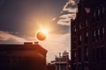 the eclipse, with the moon in front of the sun, and a view of silhouette buildings in the background