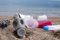 in gas mask collects garEclogy, pollution, garbage dumps near the city, lots of plastic bottles and celophane bags, rubbish Royalty Free Stock Photo