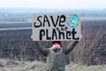 Eco activist boy holding save the planet banner. on the background of arable land. Farmland preservation concept. Royalty Free Stock Photo