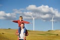 Eco activists man and child on background of power stations for renewable electric energy production. People and windmills. Wind Royalty Free Stock Photo