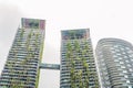 Eco architecture. Green skyscraper building with plants growing on the facade. Ecology and green living in city, urban environment Royalty Free Stock Photo