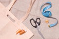 eco bag, scissors, measuring tape and several spools of thread on linen fabric Royalty Free Stock Photo