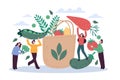 Eco bag and tiny people. Happy men and women collect large vegetables in paper bag, sustainable food packaging, organic