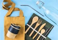 Eco bags with bamboo cutlery, reusable coffee mug and water bottle.