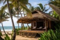 Eco bungalow or small eco house with cozy veranda and sunbeds, surrounded by palm trees, overlooking the ocean Royalty Free Stock Photo