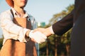 Eco-businessman handshake with farmer, eco-friendly farming. Gyre Royalty Free Stock Photo