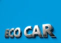 Eco car words as 3D sign or logo concept placed on blue surface with copy space above it. Eco car technologies concept. 3D Royalty Free Stock Photo