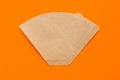 Eco coffee filter isolated on minimal orange background. Pour over method, organic zero vaste unbleached paper material Royalty Free Stock Photo