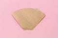 Eco coffee filter isolated on minimal pastel light pink background. Pour over method, organic zero vaste unbleached Royalty Free Stock Photo