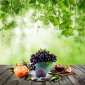 Eco concept. Fruit sweet dessert on wooden table with green grapes leaves Royalty Free Stock Photo