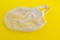 One reusable cotton net bags or mesh bags on coloured background