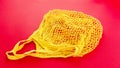 One reusable cotton net bags or mesh bags on coloured background